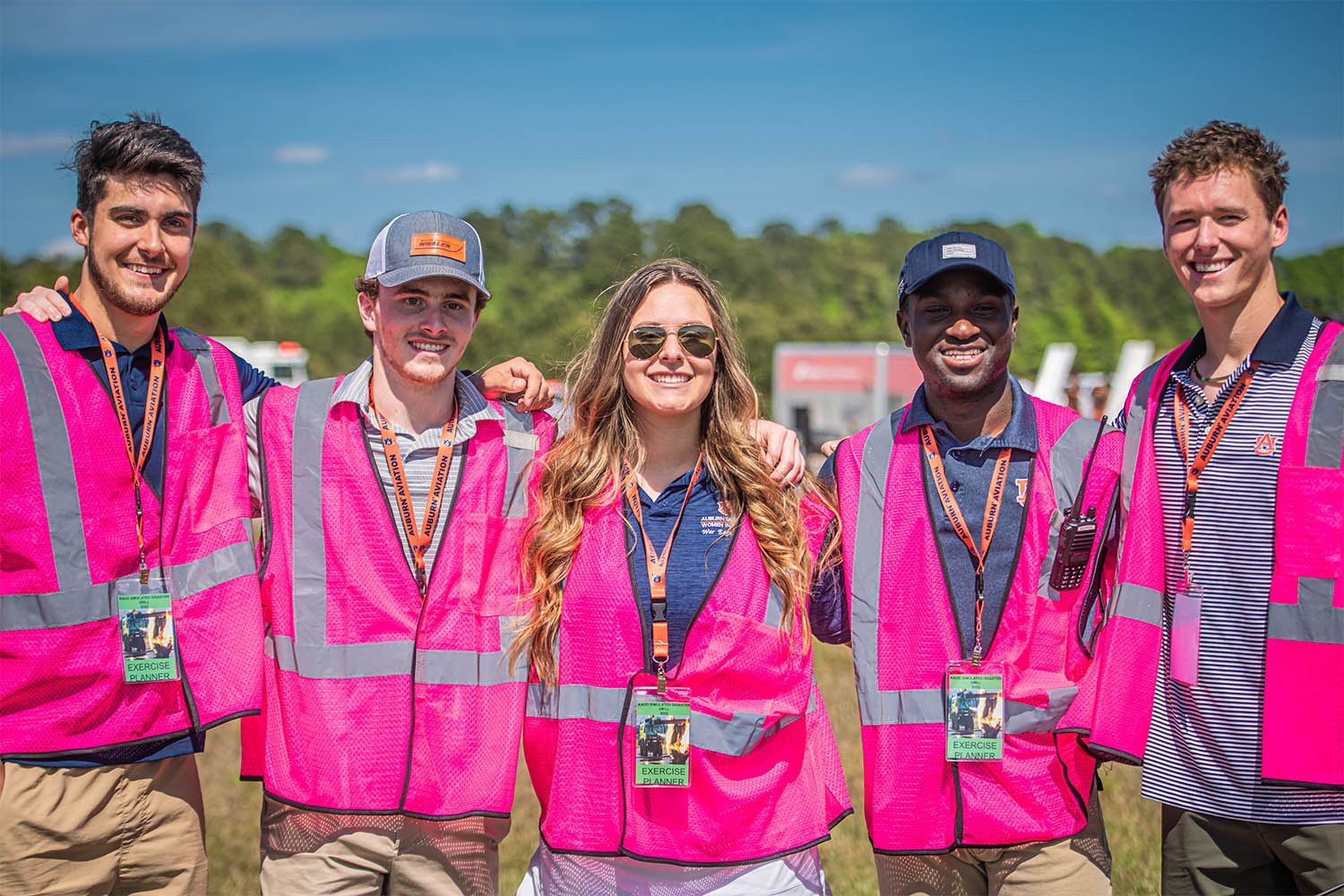 Auburn aviation students posing for picture wearing bright pink vests