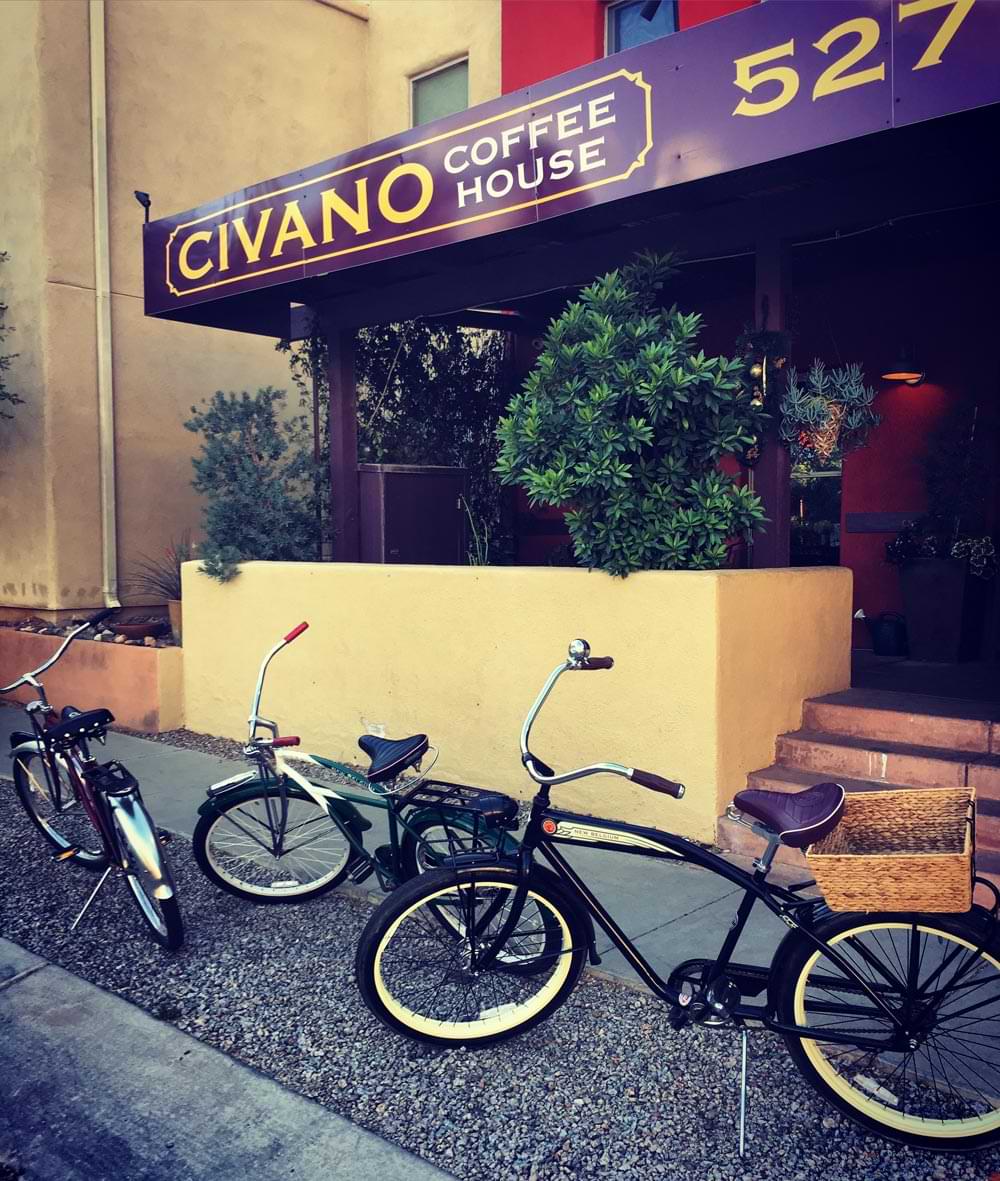 Bikes in front of a coffee house with the name Civano on a purple marquee