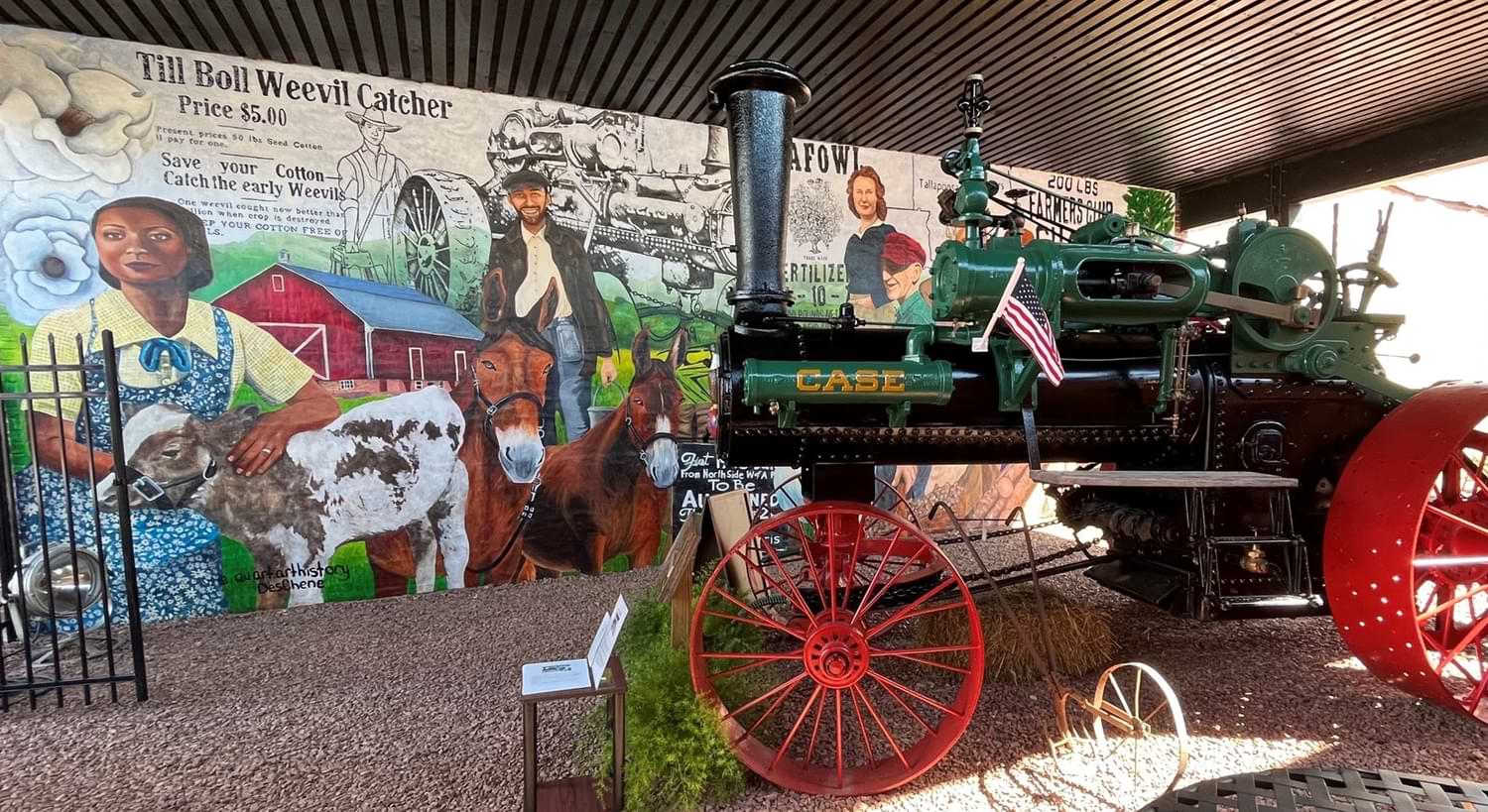 35x13 feet mural, celebrates local agricultural history and features imagery of historic equipment, advertising, local agricultural pioneers, the east Alabama landscape, farmers and farm culture. 