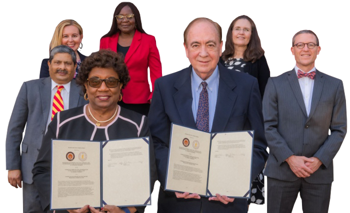 Auburn and Tuskegee faculty posing with signed partnership