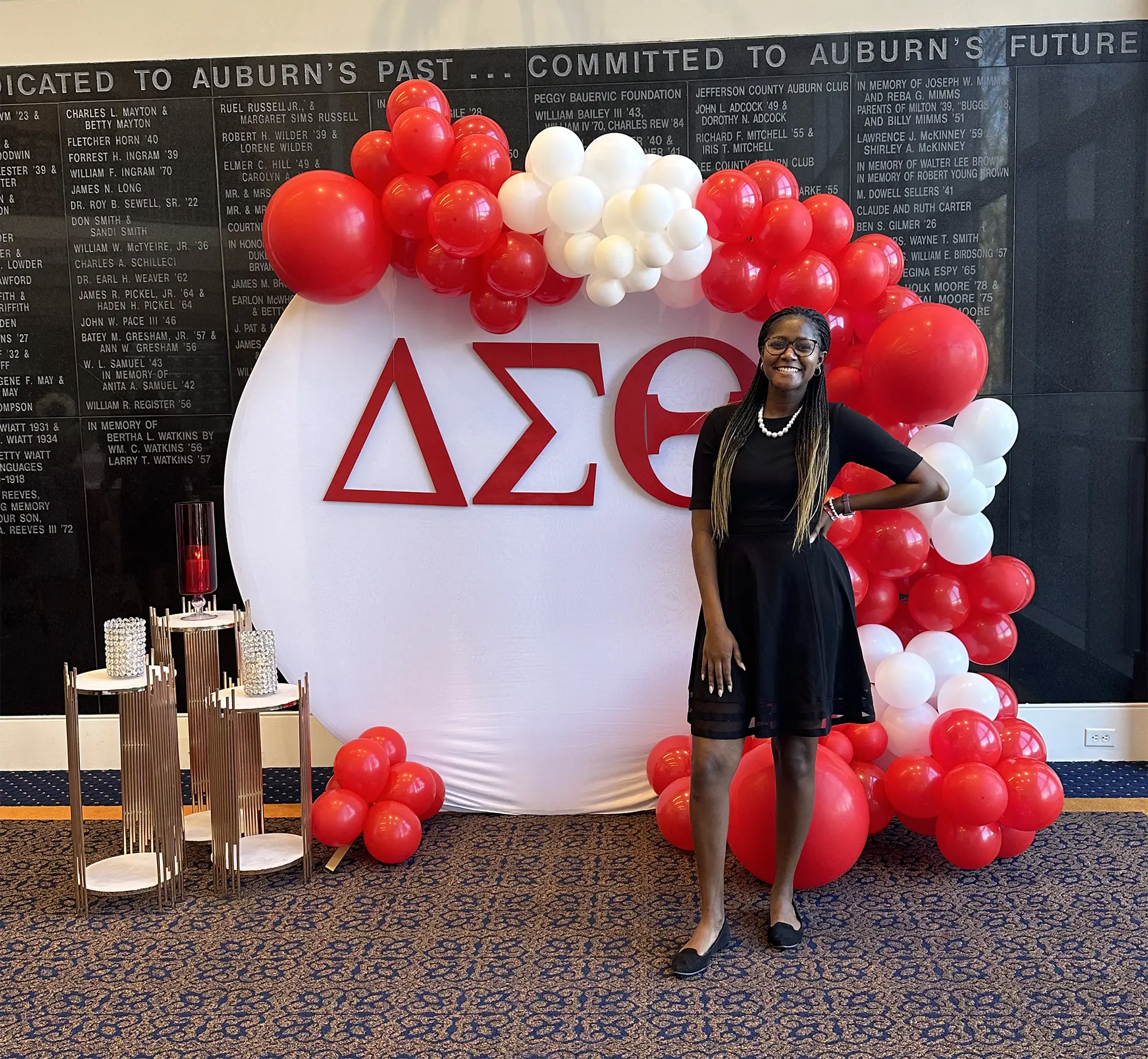 Diani standing in front of a display for her sorority
