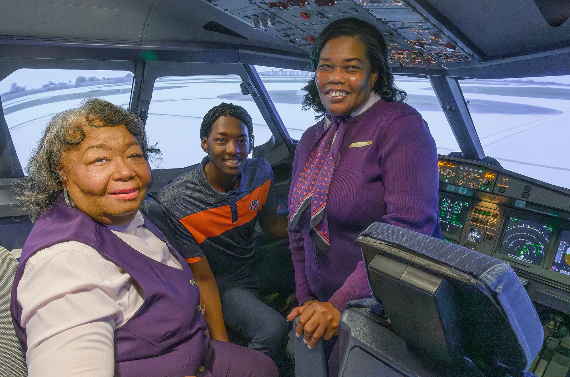 Tyler with aunt and mother in the flight simulator.