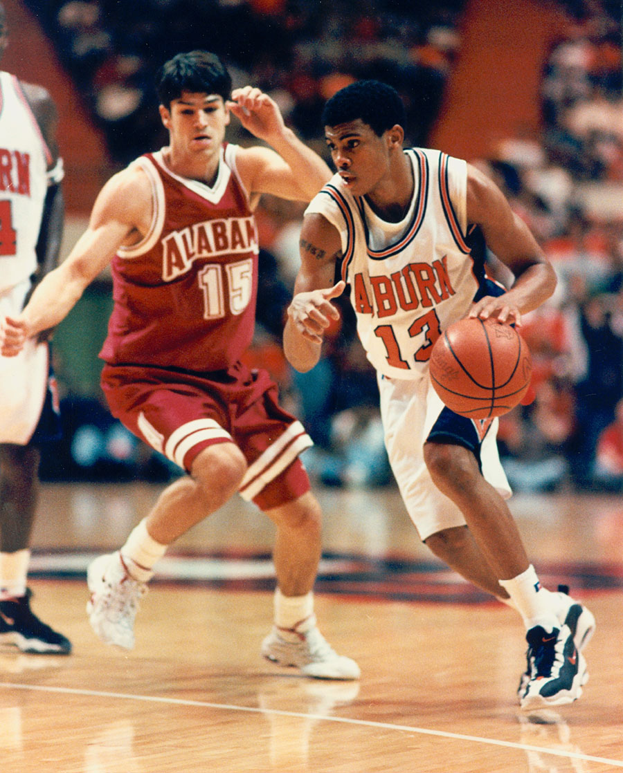 Bryant playing basketball for Auburn against Alabama.