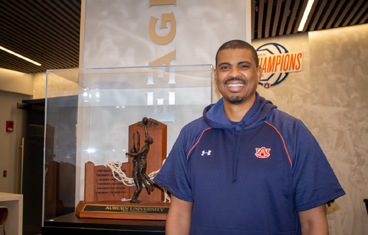Smith standing in front of 1999 SEC Champions Trophy