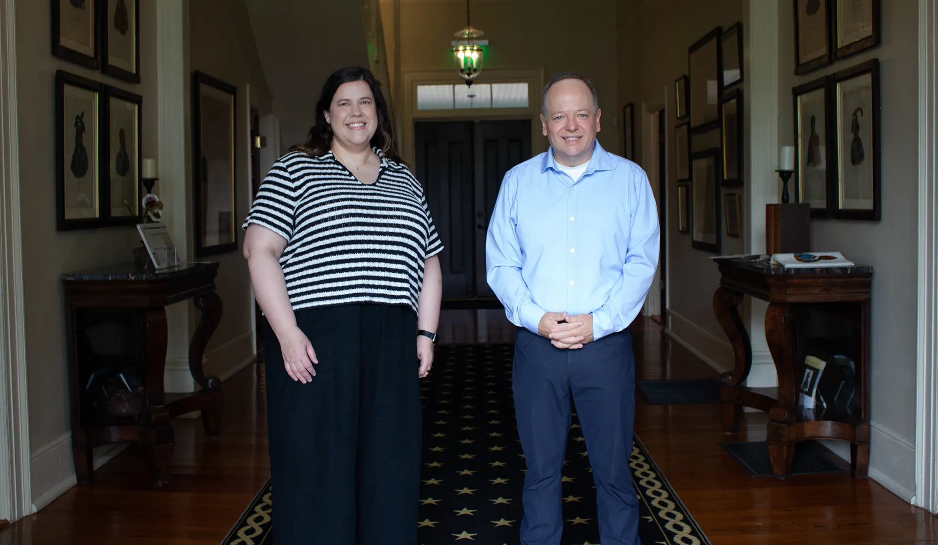 Maiben and Mark standing in Pebble Hill hallway.