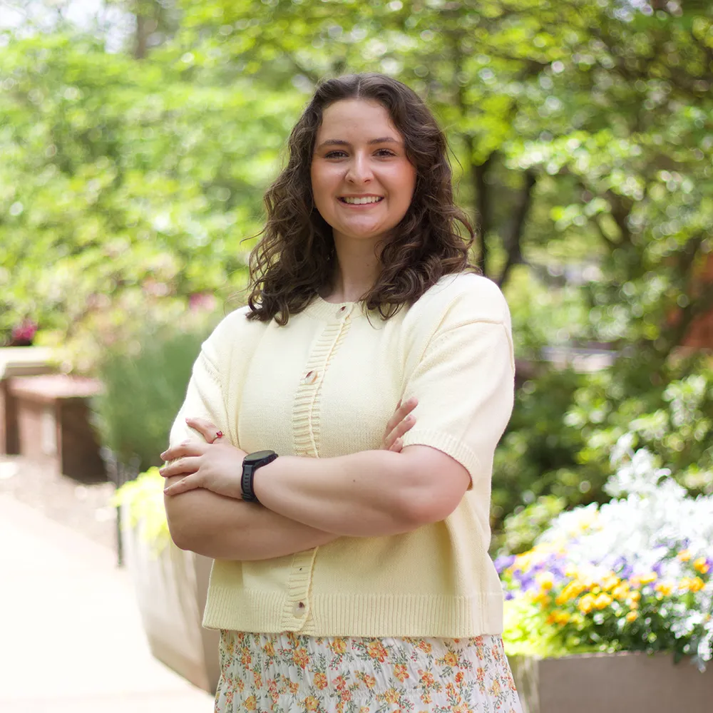 Sofia wearing yellow standing in Samford concourse