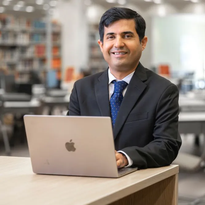 Shah with computer in AU Library