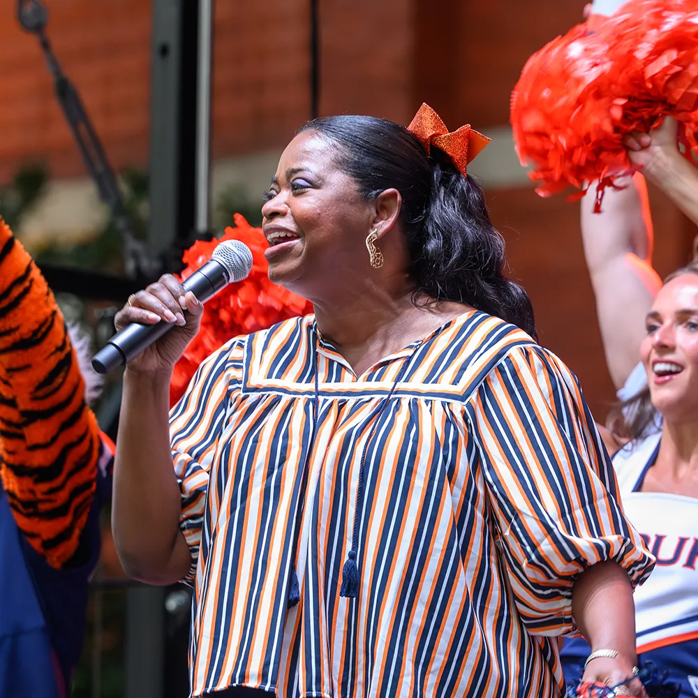 Spencer on stage with Aubie and cheerleaders